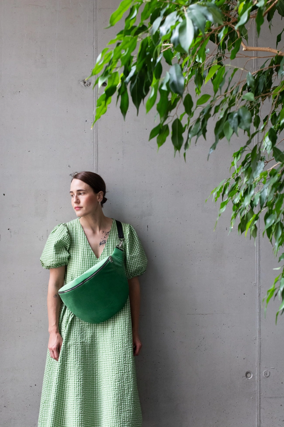 Jasnozielona nerka aksamitna, Ouiet Green. Trwały materiał. Okucia w jasnym srebrze. Prezentowana przez modelkę, w pojemnym rozmiarze cubage, z paskiem z czarnej taśmy 40mm. Noszona na skos, przez ramię.